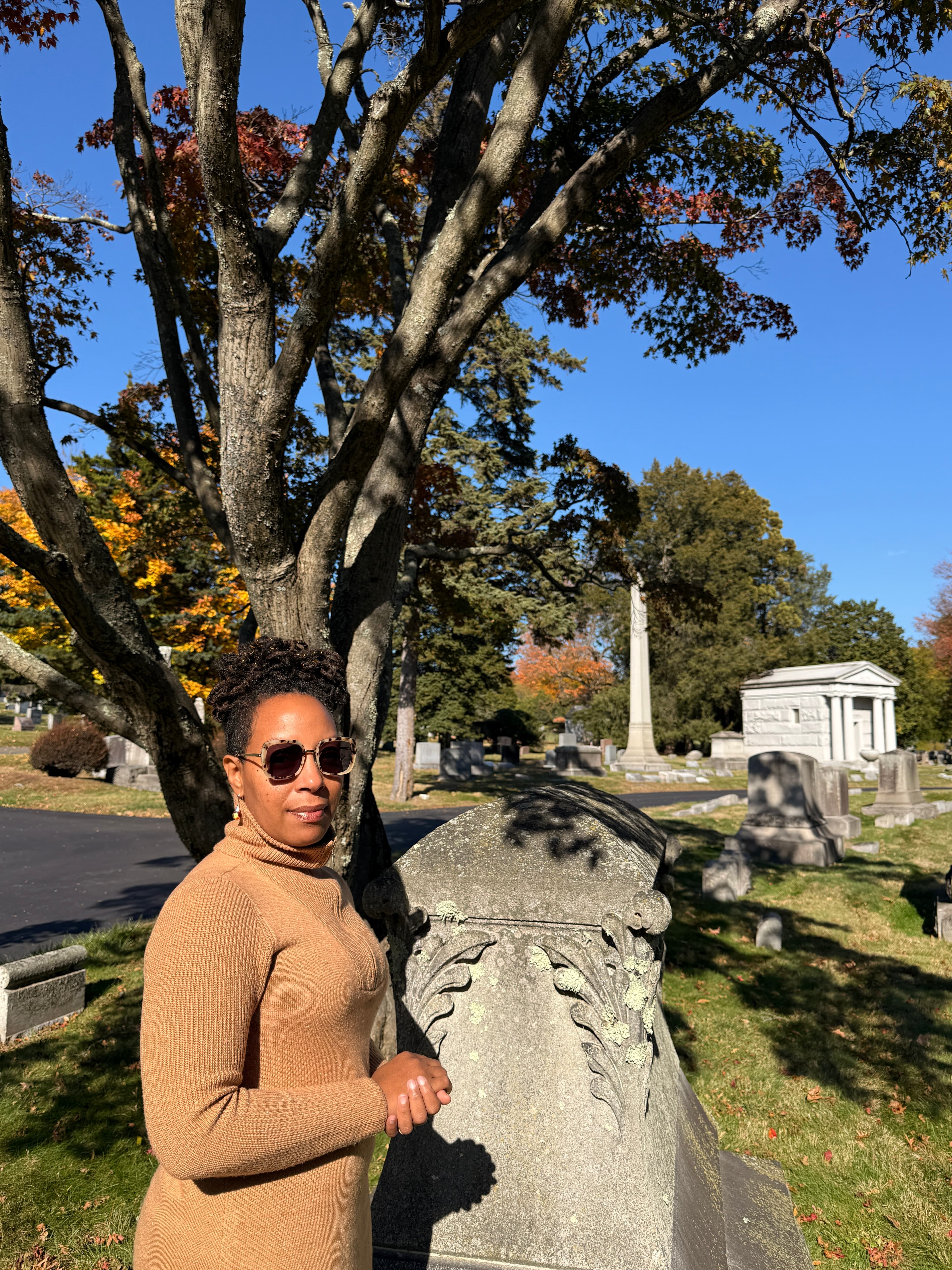 Founder standing among autumn trees